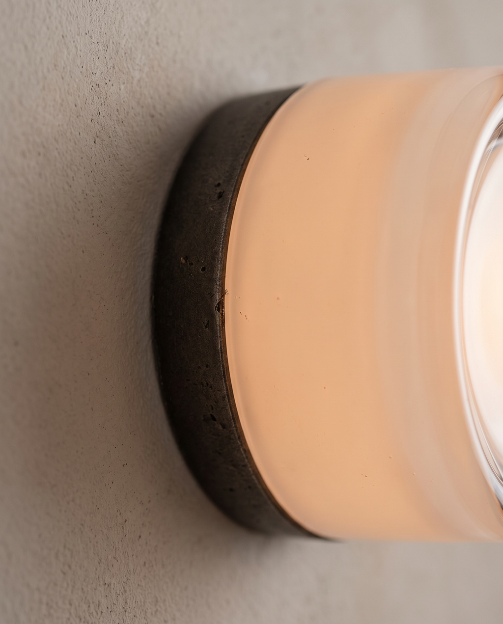 Minimalist Linear LED Wall Sconce, Aluminum and Iron — macro detail of glass and iron finish, warm glow