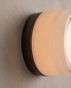 Minimalist Linear LED Wall Sconce, Aluminum and Iron — macro detail of glass and iron finish, warm glow