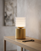 Rechargeable Acrylic Diffuser Table Lamp, Touch Dimming — Gold, glowing on a modern console table