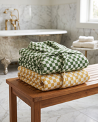 Green and Yellow Plaid Organic Cotton Bathrobe — folded spa stack of green and yellow, marble bathroom