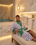 Yarn-Dyed Stripe Organic Cotton Bathrobe — Green & Purple, adult model wearing, luxury spa hotel bathroom