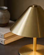 Cordless Touch LED Lamp, Gold and Silver Metal — detail macro of brushed metal and warm glow, studio close-up