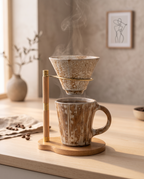 Pour-Over Coffee Dripper Set, Ceramic and Wood Stand — mid-brew with coffee and steam in a warm Japandi coffee corner