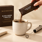 Pouring a Maudestry sachet into a hot mug