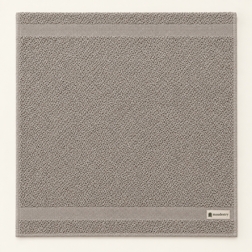 Towel laid flat, showing the woven border