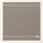 Towel laid flat, showing the woven border