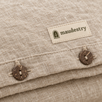 Close-up of the coconut-shell buttons and Maudestry label